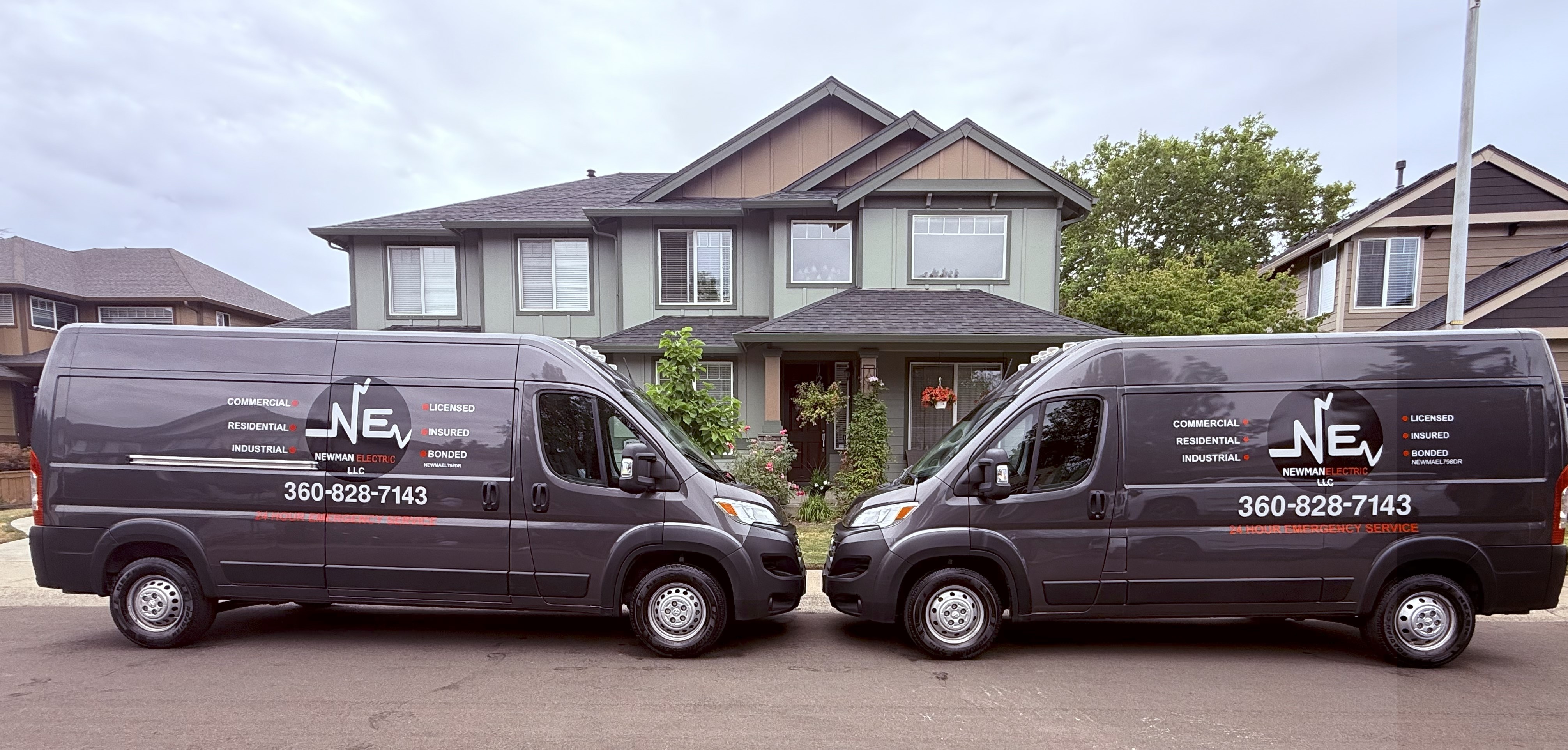 Newman Electric branded service vans parked in front of a home in Vancouver WA